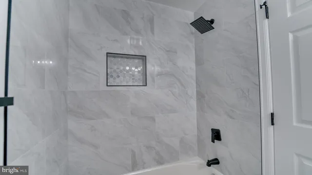 a bathroom with a sink vanity mirror and toilet