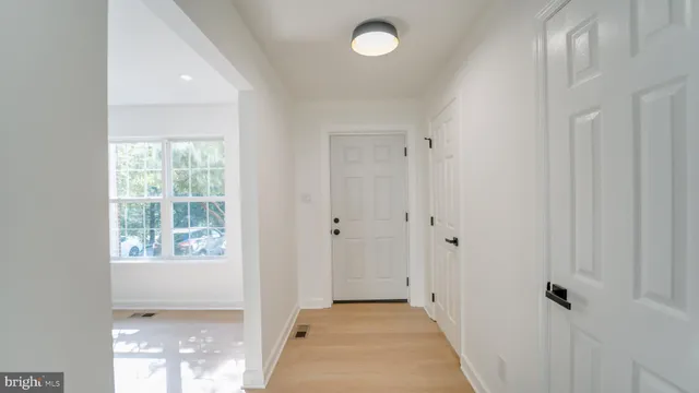 a view of a hallway with a window and a livingroom
