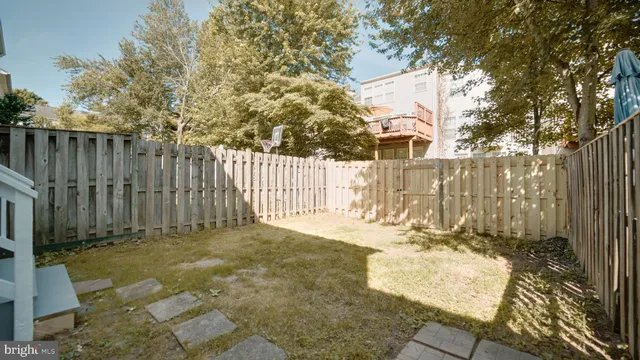 an aerial view of multiple house with large trees