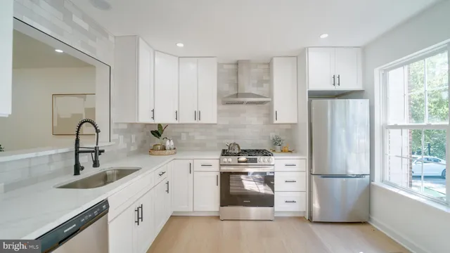 a kitchen with a sink a refrigerator and a stove