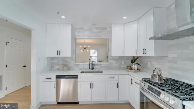 a kitchen with a sink stove and cabinets