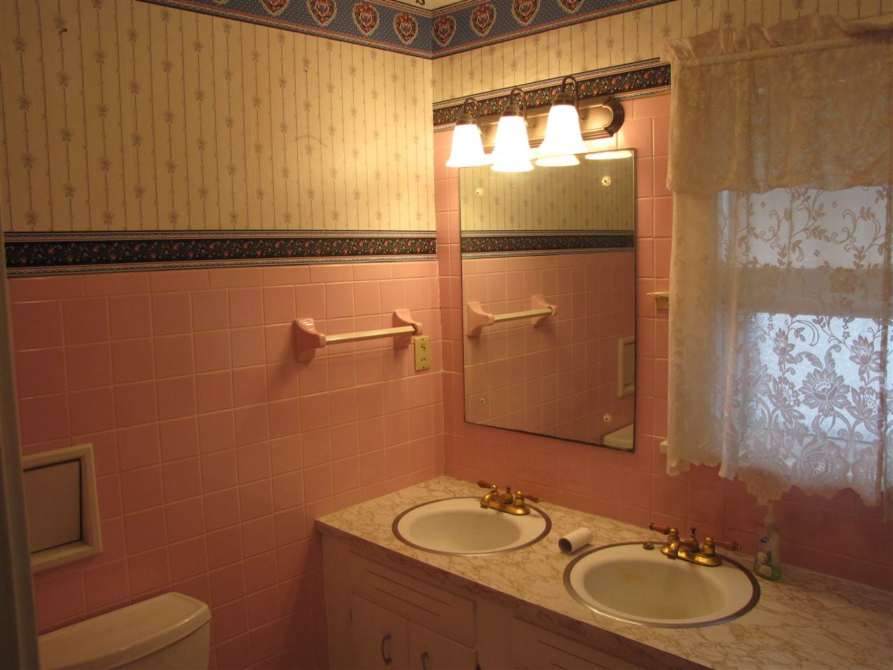 2011 Rural Street Rockford, IL 61107 - Photo 9 of 17 a bathroom with a sink and mirror with toilet