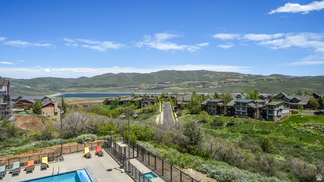 1364 Still Water Drive, Unit R2012 Heber City, UT 84032 - Photo 15 of 30 Outdoor swimming pool with integrated hot tub, surrounded by a metal fence