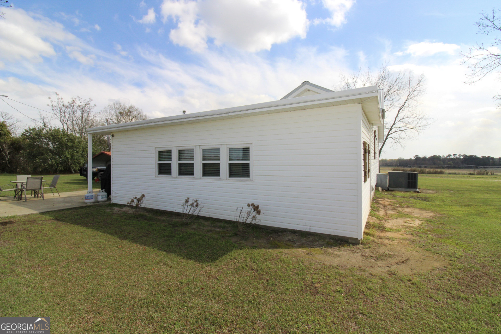 427 Pulaski High School Road Hawkinsville, GA 31036 - Photo 23 of 29 a view of a house with pool and a yard