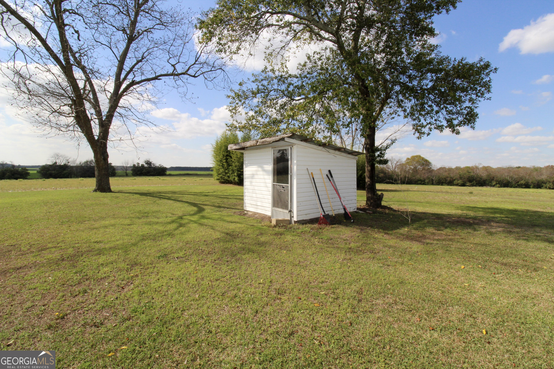 427 Pulaski High School Road Hawkinsville, GA 31036 - Photo 28 of 29 a view of a house with a yard and garage
