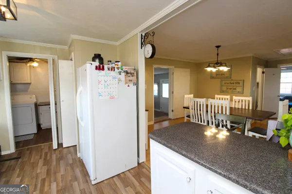 a view of a livingroom with furniture and kitchen view