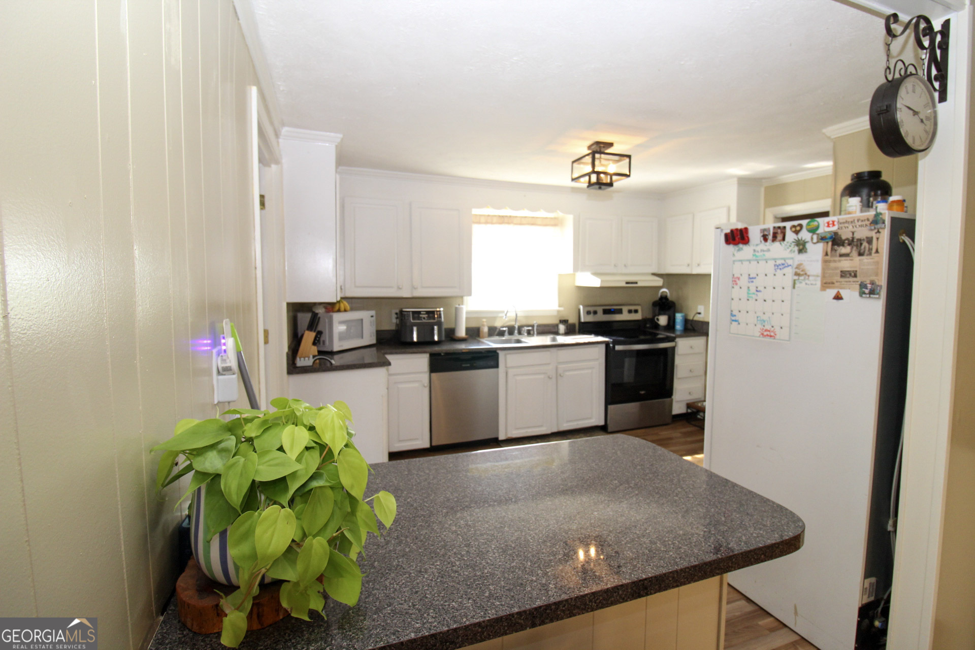 427 Pulaski High School Road Hawkinsville, GA 31036 - Photo 10 of 29 a kitchen with refrigerator and white cabinets