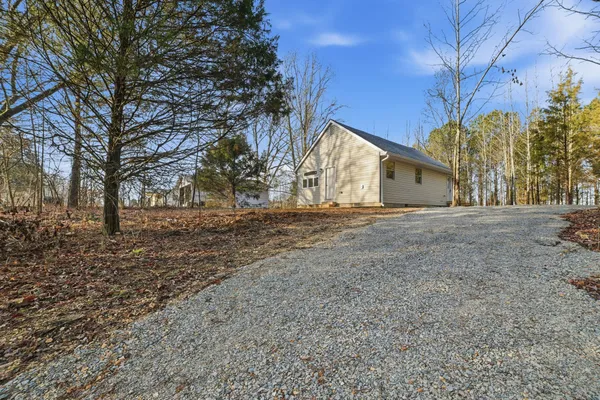 a view of dirt yard with a tree