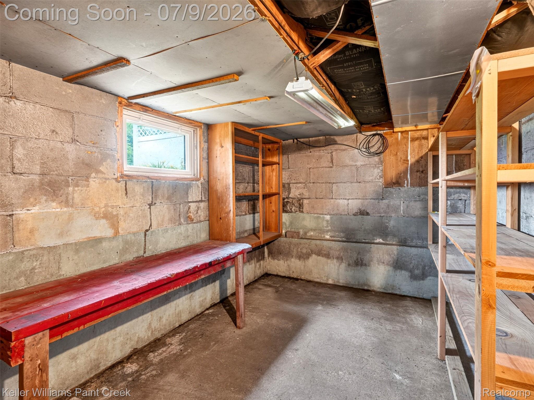 204 Russell Road Kawkawlin, MI 48631 - Photo 51 of 82 Unfinished basement space featuring concrete block walls, a concrete floor, and exposed ceiling joists