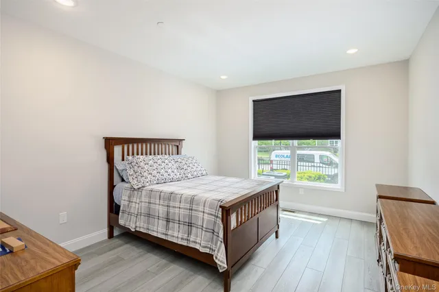 a living room with furniture a flat screen tv and a large window