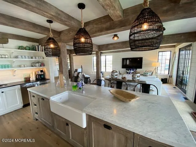 a kitchen with stainless steel appliances granite countertop a sink a stove and a refrigerator