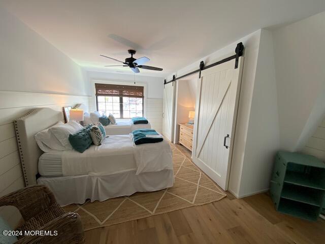 608 Lake Avenue Point Pleasant Beach, NJ 08742 - Photo 27 of 31 a bedroom with a bed and a chandelier