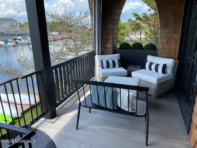 a view of a chairs and table in the balcony