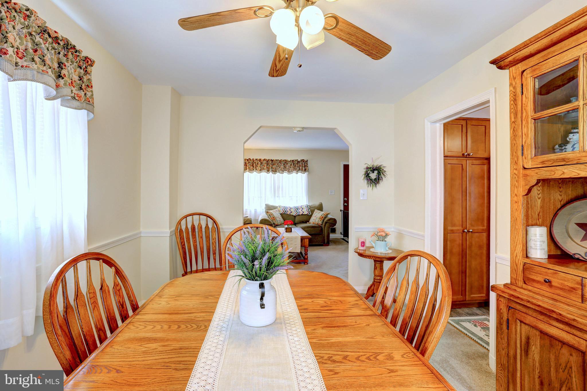 123 Garden Ridge Road Baltimore, MD 21228 - Photo 11 of 29 a view of a dining room with furniture window and wooden floor
