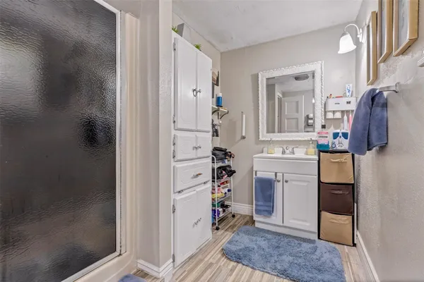 a room with a walk in closet and a mirror