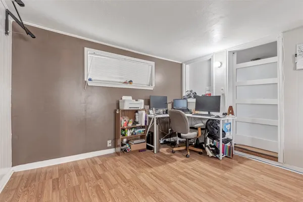 a view of a workspace with furniture and wooden floor