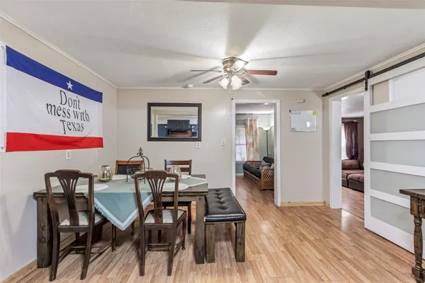 a view of a dining room with furniture and wooden floor
