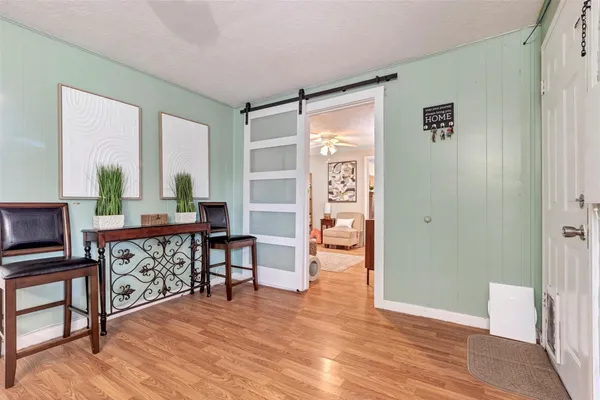 a view of a livingroom with furniture and hardwood floor
