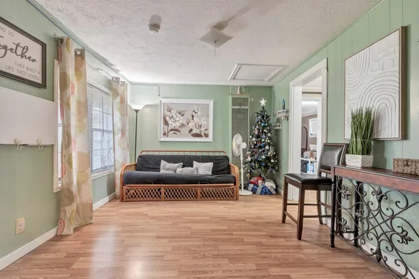 a living room with furniture and a painting on the wall