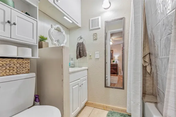 a bathroom with a toilet sink and shower