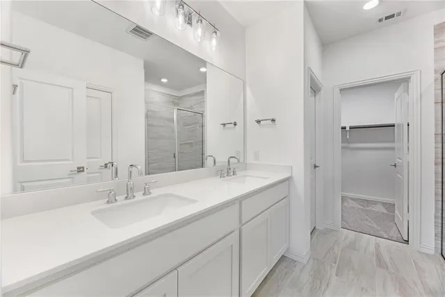 a bathroom with a sink double vanity and a mirror