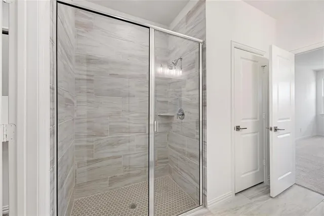 a bathroom with a glass shower door