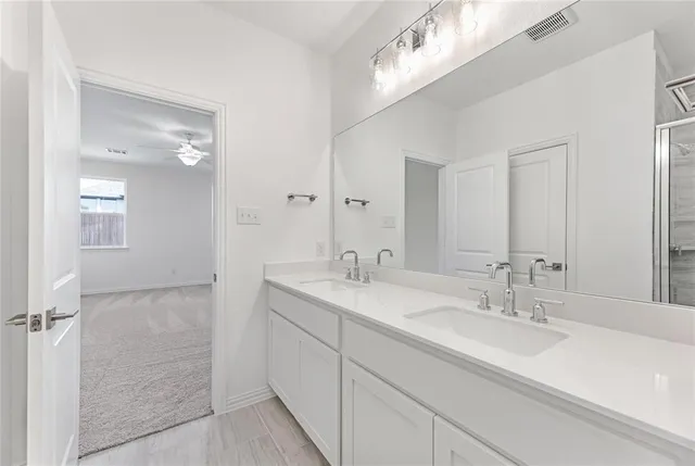 a bathroom with a sink double vanity and a mirror