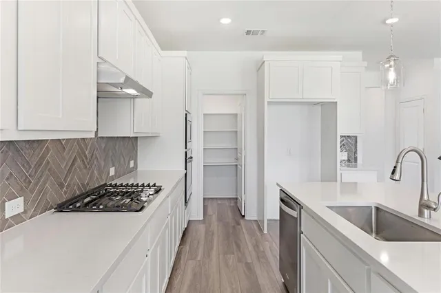a kitchen with a refrigerator and a sink