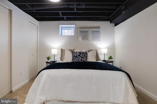 a bedroom with a bed and a white cabinet
