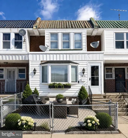 a front view of a house with plants