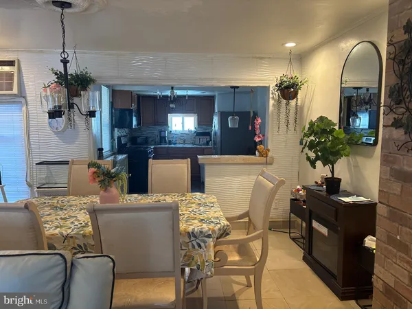 a living room with furniture flowers and a chandelier