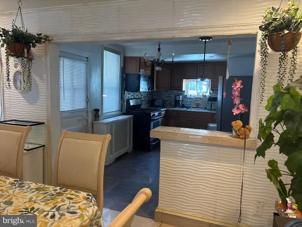 a kitchen with stainless steel appliances kitchen island granite countertop a refrigerator and a stove