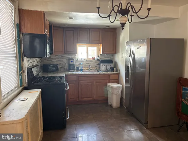 a kitchen with a refrigerator and a sink
