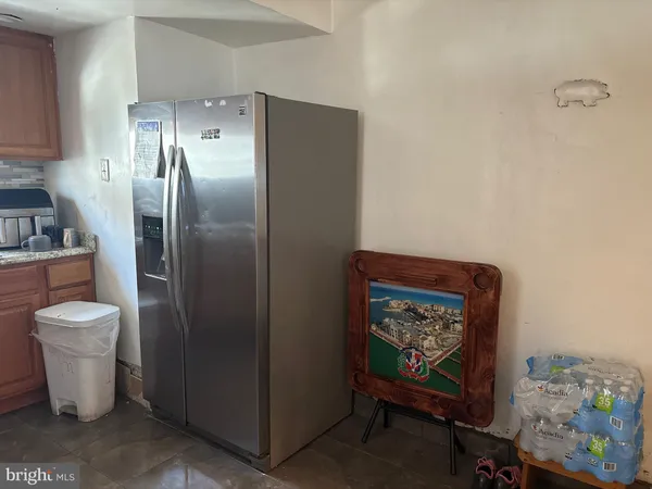 a kitchen with a refrigerator and a stove