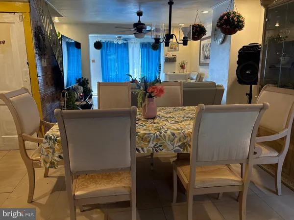 a dining room with furniture and wooden floor