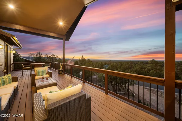 a view of a balcony with wooden floor and city view