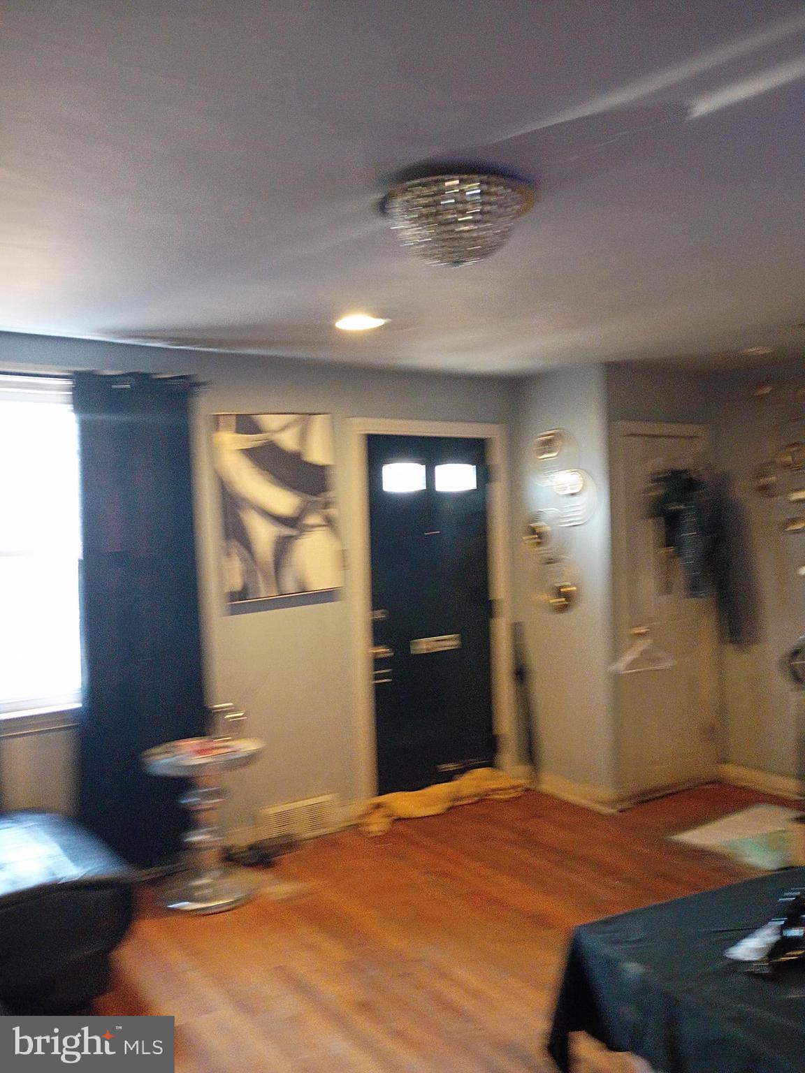 7555 Sherwood Road Philadelphia, PA 19151 - Photo 2 of 10 a bedroom with a bed and a window