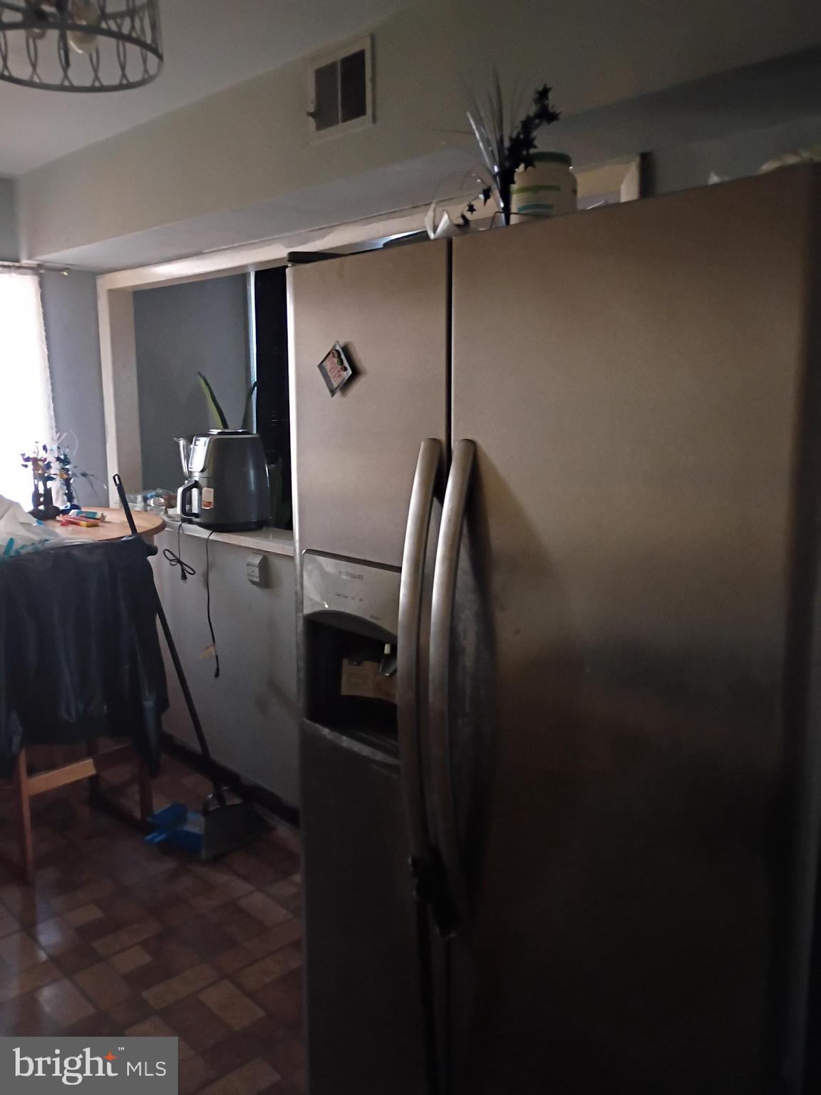 7555 Sherwood Road Philadelphia, PA 19151 - Photo 3 of 10 a kitchen with a refrigerator a washer dryer and washer