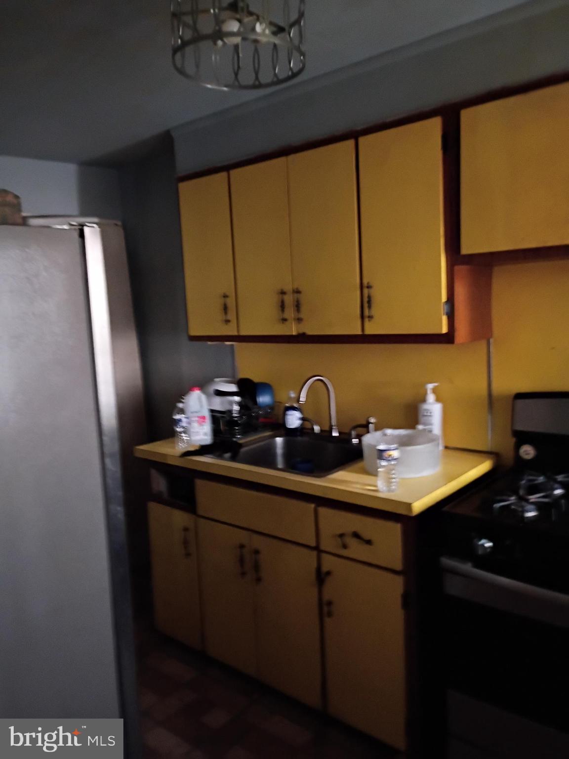 7555 Sherwood Road Philadelphia, PA 19151 - Photo 5 of 10 a kitchen with a sink a refrigerator and cabinets