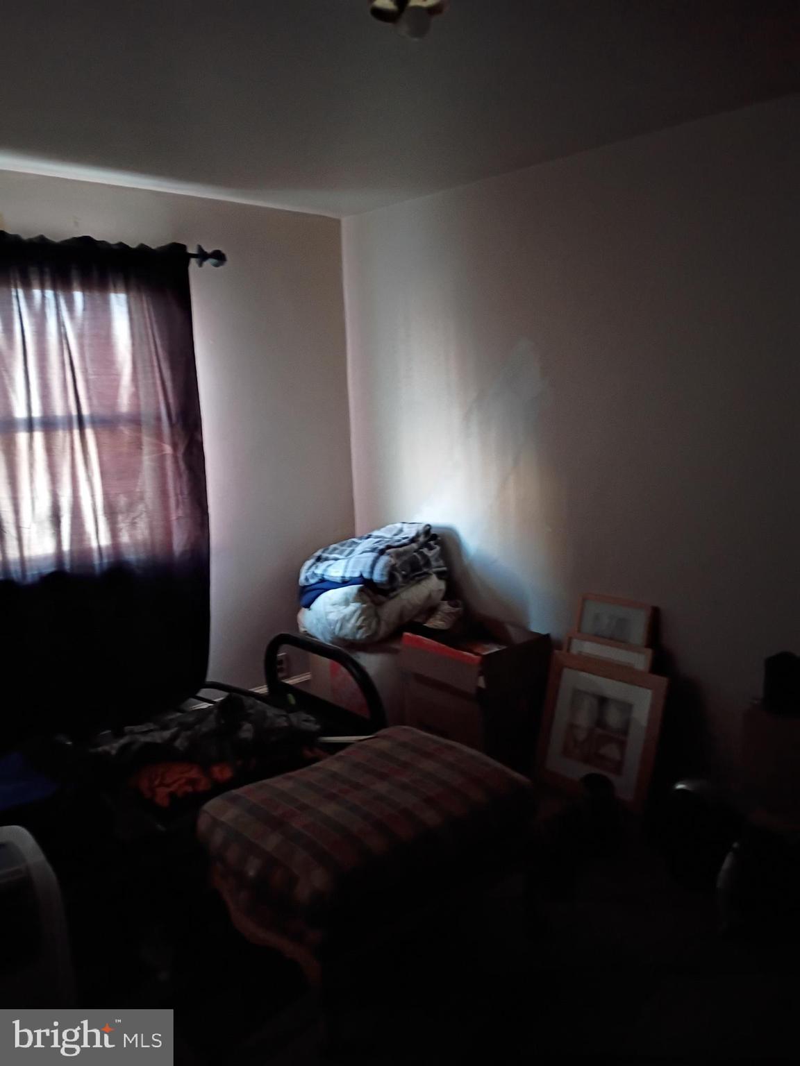 7555 Sherwood Road Philadelphia, PA 19151 - Photo 8 of 10 a bedroom with bed and window