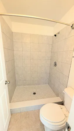 a bathroom with a toilet and shower