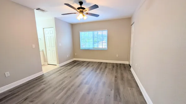 wooden floor in an empty room with a window