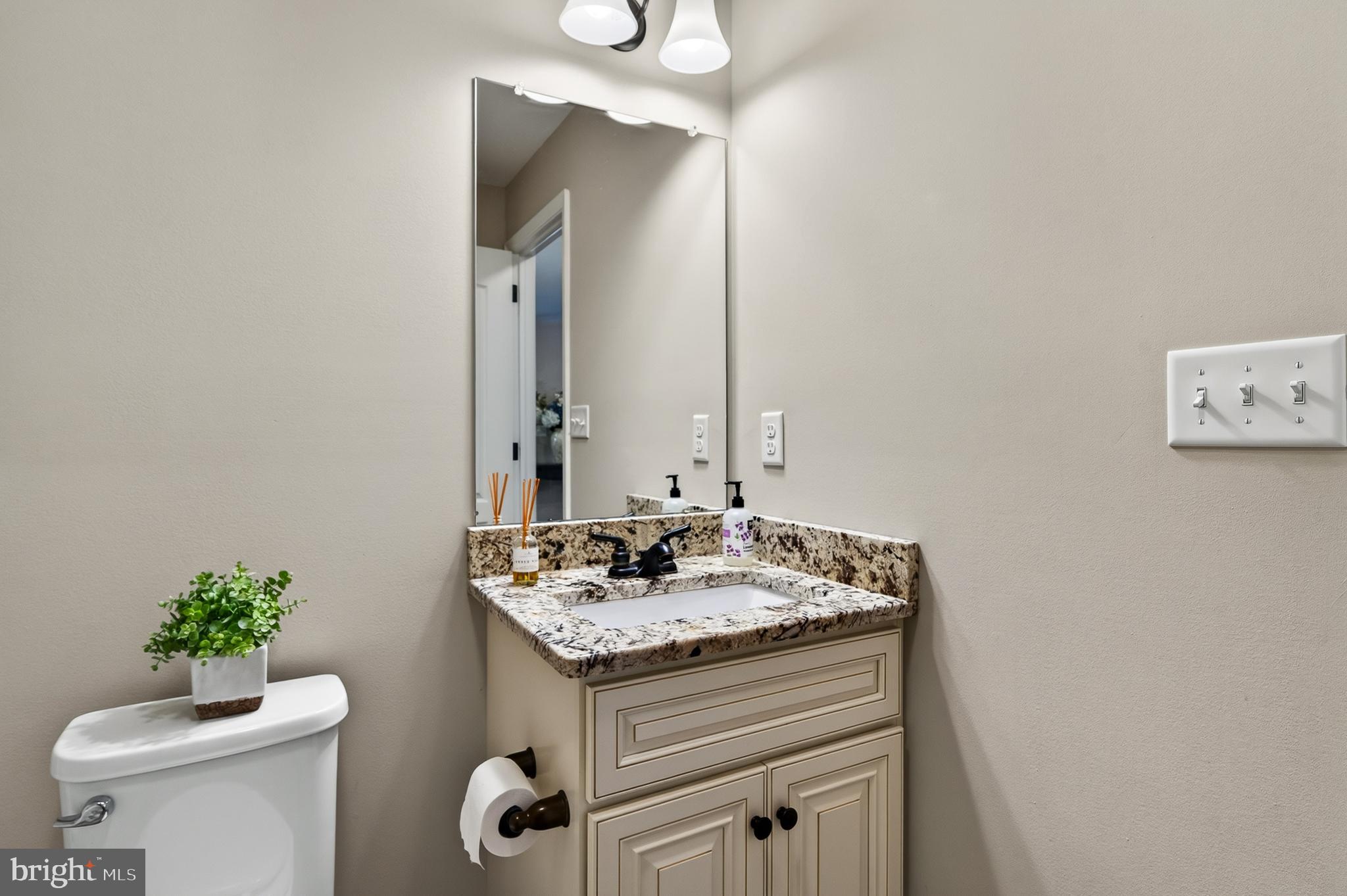 246 Oak Park Road Hatfield, PA 19440 - Photo 23 of 45 a bathroom with a granite countertop sink and a mirror