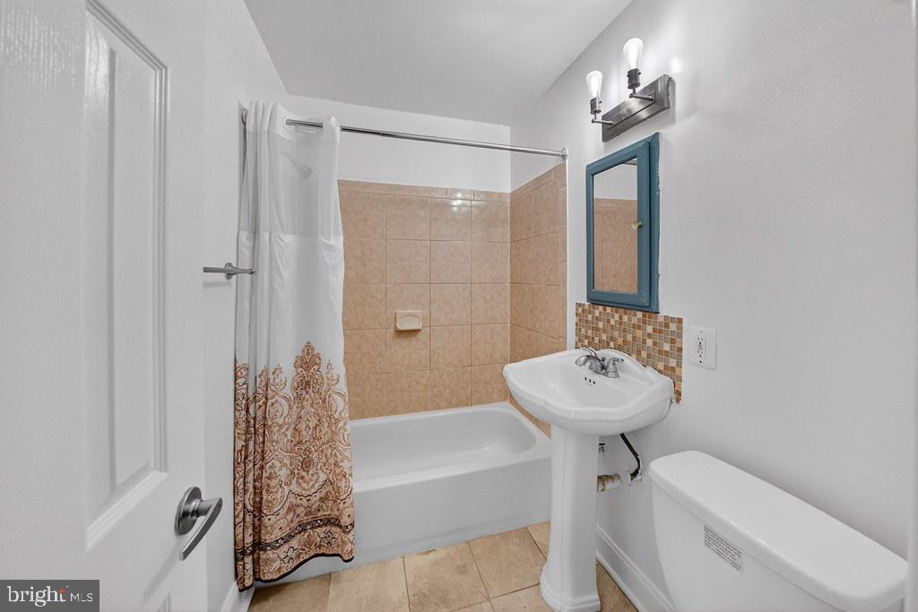 1005 Chillum Road, Unit 207 Hyattsville, MD 20782 - Photo 12 of 21 a bathroom with a sink a toilet and shower
