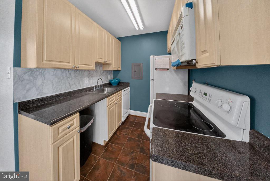 1005 Chillum Road, Unit 207 Hyattsville, MD 20782 - Photo 13 of 21 a kitchen with stainless steel appliances granite countertop a sink and a stove