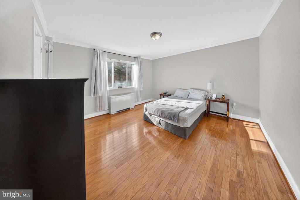 1005 Chillum Road, Unit 207 Hyattsville, MD 20782 - Photo 9 of 21 a bedroom with a bed and wooden floor