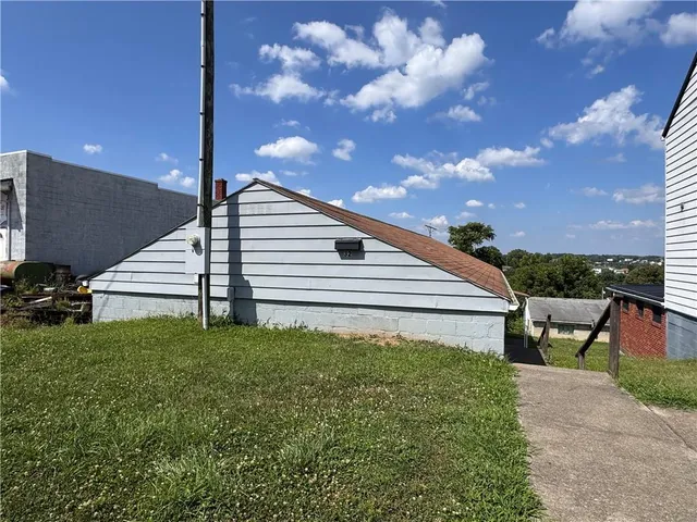 a view of a backyard with sitting area