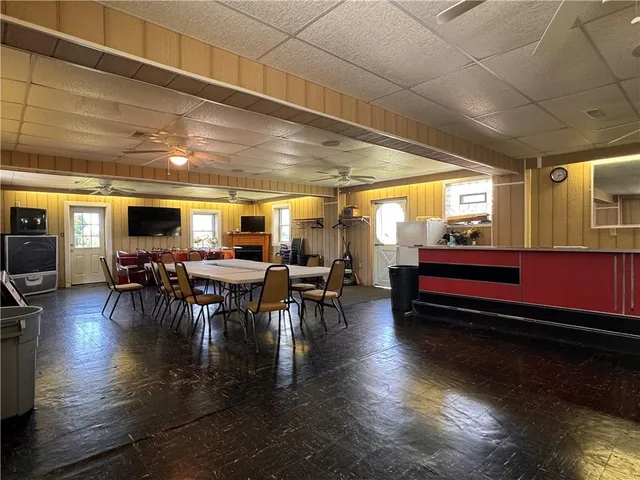 a room with lots of wooden furniture and a dining table