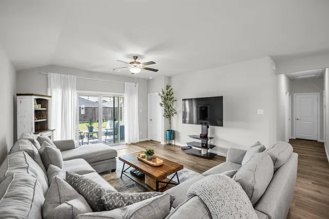 a living room with furniture and a flat screen tv