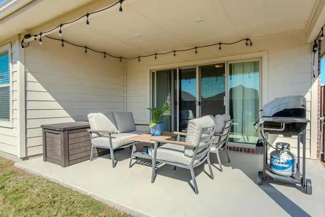 a building outdoor space with patio furniture and potted plants